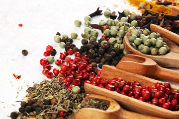 Spices with pepper on table. Food and cuisine ingredients for cooking on rustic background