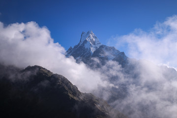 clouds and fogs surround the beautiful mountain machhapuchhre