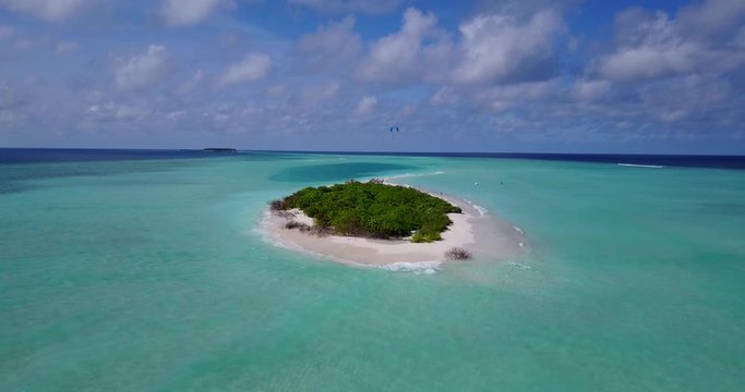Skydiving over the small uninhabited tropical island, aerial background