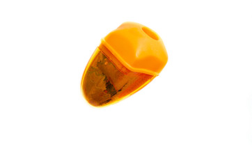 Orange pencil sharpener whole and torn with shavings inside on a white background