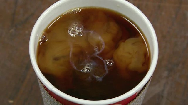 Slow Motion Cream Swirling In Coffee Close Up - 120 fps