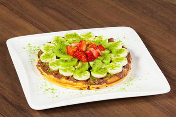 Belgian chocolate waffles with strawberries, kiwi, banana and chocolate