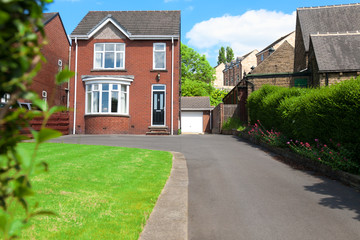 Typical English single family house built of red bricks, with a large driveway - obrazy, fototapety, plakaty