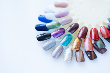 Palette of nail polish for manicure on white background