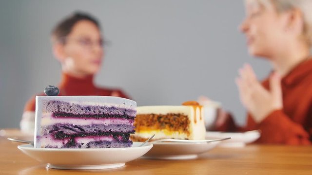 Pieces of cake are standing on the wooden table