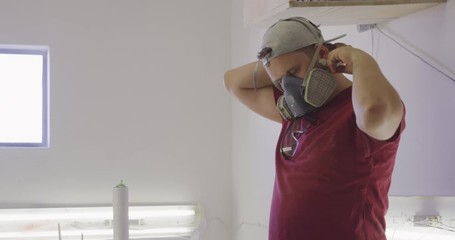 Male surfboard maker in his workshop - Powered by Adobe