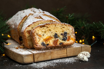 Traditional fruit cake for Christmas with raisins, nuts. with Christmas background.