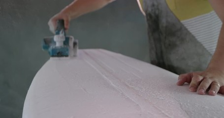 Male surfboard maker in his workshop - Powered by Adobe