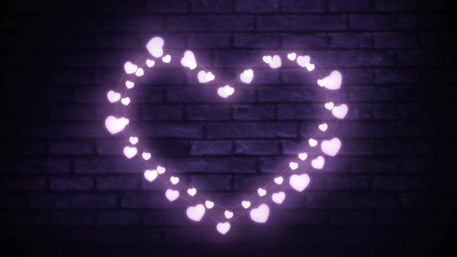 Glowing heart of fairy lights on brick wall