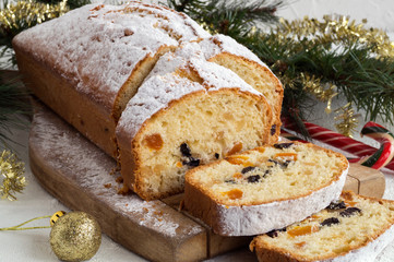 Traditional fruit cake for Christmas with raisins, nuts. with Christmas background.