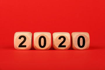 Wooden cubes with 2020 word over red