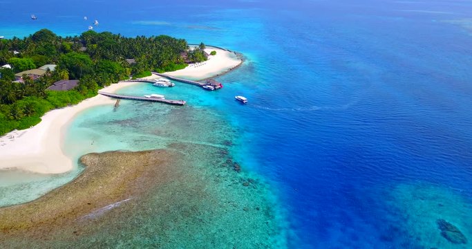 Tour Boat Approaching Dock Of The Topical Caribbean Island. Aerial Motion Background