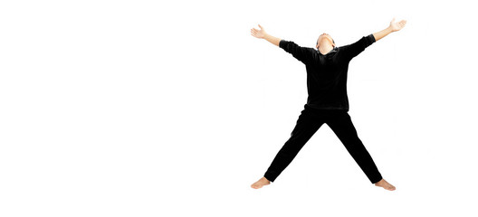 Full-length shot of male teenager doing stretching exercises isolated on white by spreading his...