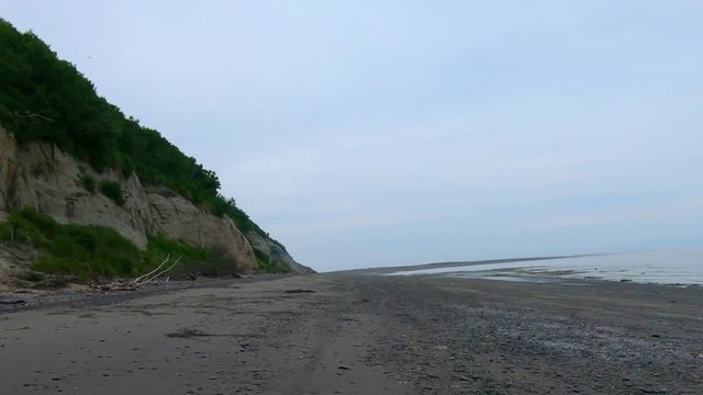 POV through rear window of an off road vehicle driving on an isolated beach on the Kenai Penisula of Alaska