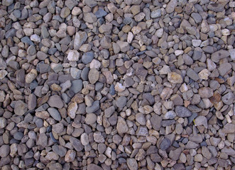 Abstract Full frame gray gravel stones image, ideal background or texture at the afternoon