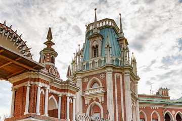 Fototapeta premium Tower of Grand Palace in Tsaritsyno Park against cloudy sky in autumn day. Tsaritsyno Park is popular touristic place in Moscow