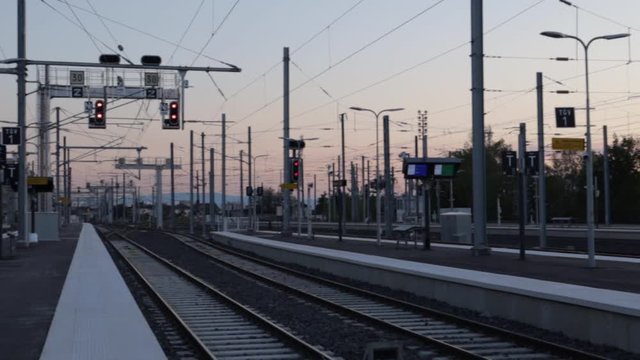 empty train stations with no one on the platforms during evening sunset, panning shot