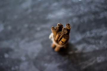 Top view of cinnamon sticks on grey background.