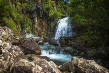 Fototapeta na wymiar Korbu Waterfall at Lake Teletskoye in the Altai Mountains. The most famous lake waterfall