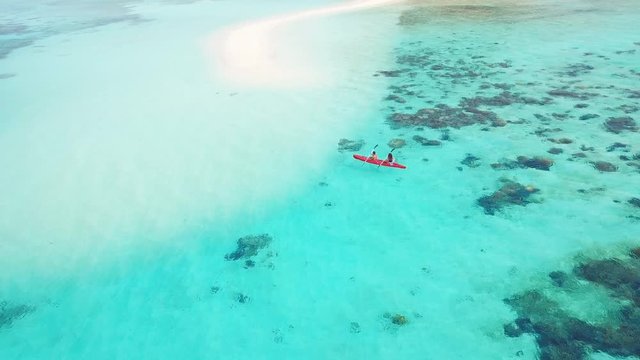 Kayak With Couple in Turquoise Water by Remote Tropical Philippines Island With White Beach Sand Bar and Coral Reef, Aerial