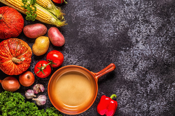 Fresh autumn vegetables for cooking on a dark background.