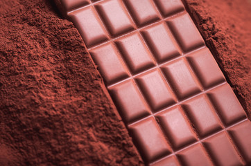Chocolate on cocoa powder close-up. Chocolate background
