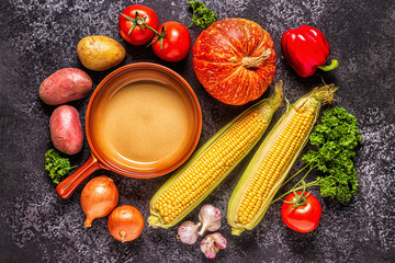 Fresh autumn vegetables for cooking on a dark background.