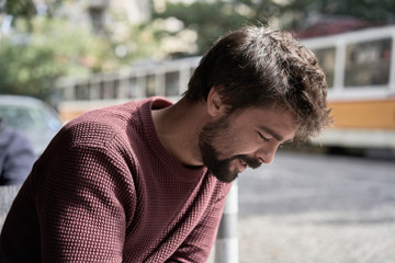 Attractive young bearded man using his smartphone in the cafe