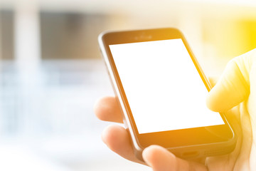 hand holding smartphone with blank screen, with sunlight.