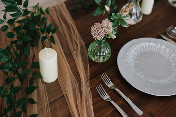 Place setting on wooden table.  Wedding inspiration. Wedding decorations for table in rustic style. 