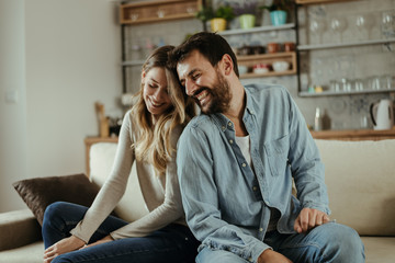 Young happy couple spending their time at home