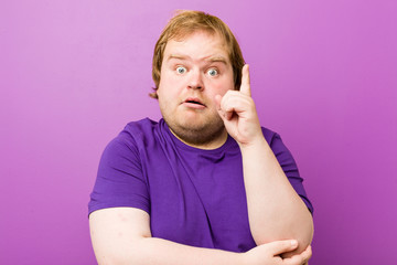 Young authentic redhead fat man having some great idea, concept of creativity.
