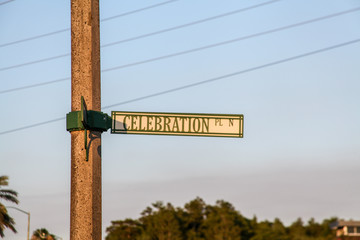The sign on a square wooden pole indicating the address: Celebration PL N in Florida