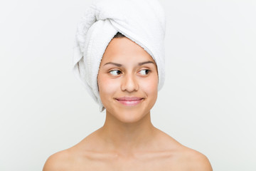 Close up of a beautiful and natural hispanic young woman with a towel on her head