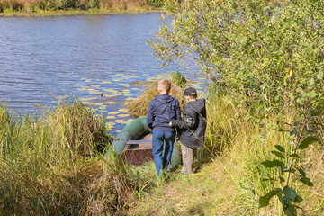 Children prepare an inflatable boat for launching