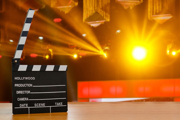 Slate film, Film clapper or Movie director slate on wood table with De-focused concert crowd. background. for production of film Concept