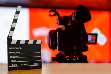 Slate film, Film clapper or Movie director slate on wood table with De-focused concert crowd. background. for production of film Concept