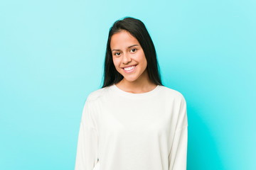 Young pretty hispanic woman happy, smiling and cheerful.