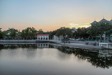 The magnificent sunset landscape at Celebration, Orlando, Florida, USA. A modern design leisure area in a wooded area, the water mirror on the lake reminiscent of nature.