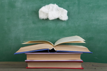 Education and reading creative concept - open under the cotton clouds book, inspiration for a fairy tale