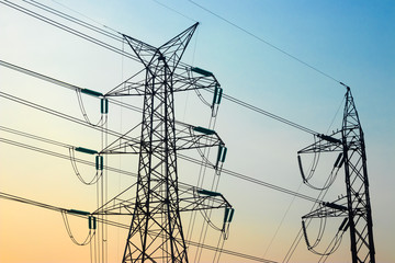 High-power pylon with morning light, with blue sky view