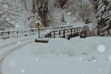 wooden bridge in the austrian alps, covered with snow