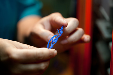 hands holding shapes for casting golden jewelry