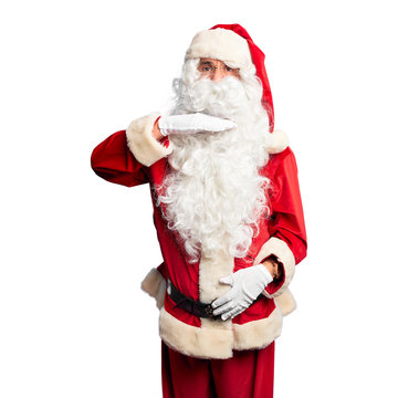 Middle age handsome man wearing Santa Claus costume and beard standing cutting throat with hand as knife, threaten aggression with furious violence