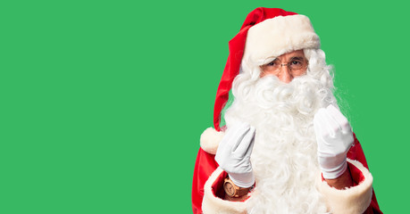 Middle age handsome man wearing Santa Claus costume and beard standing doing money gesture with hands, asking for salary payment, millionaire business