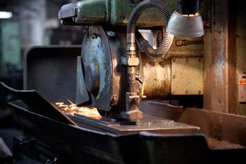closeup of metallic lathe working with factory industrial interior background