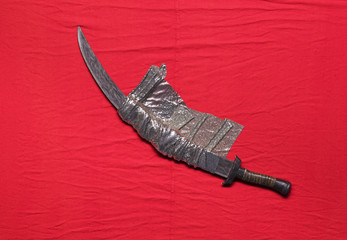 medieval sword isolated on red background