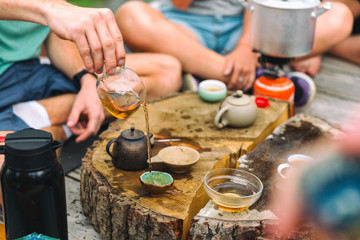 Tea ceremony. Lots of small cups. On an old stump. Health. On nature - 297894686