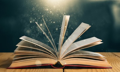 Open book on old wooden table