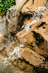 Water stream of a fountain splashing drops
